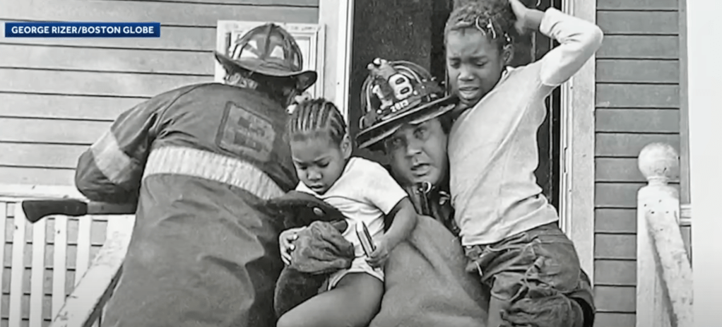 Umar Fox rescued by firefighter Joseph Gilmore.